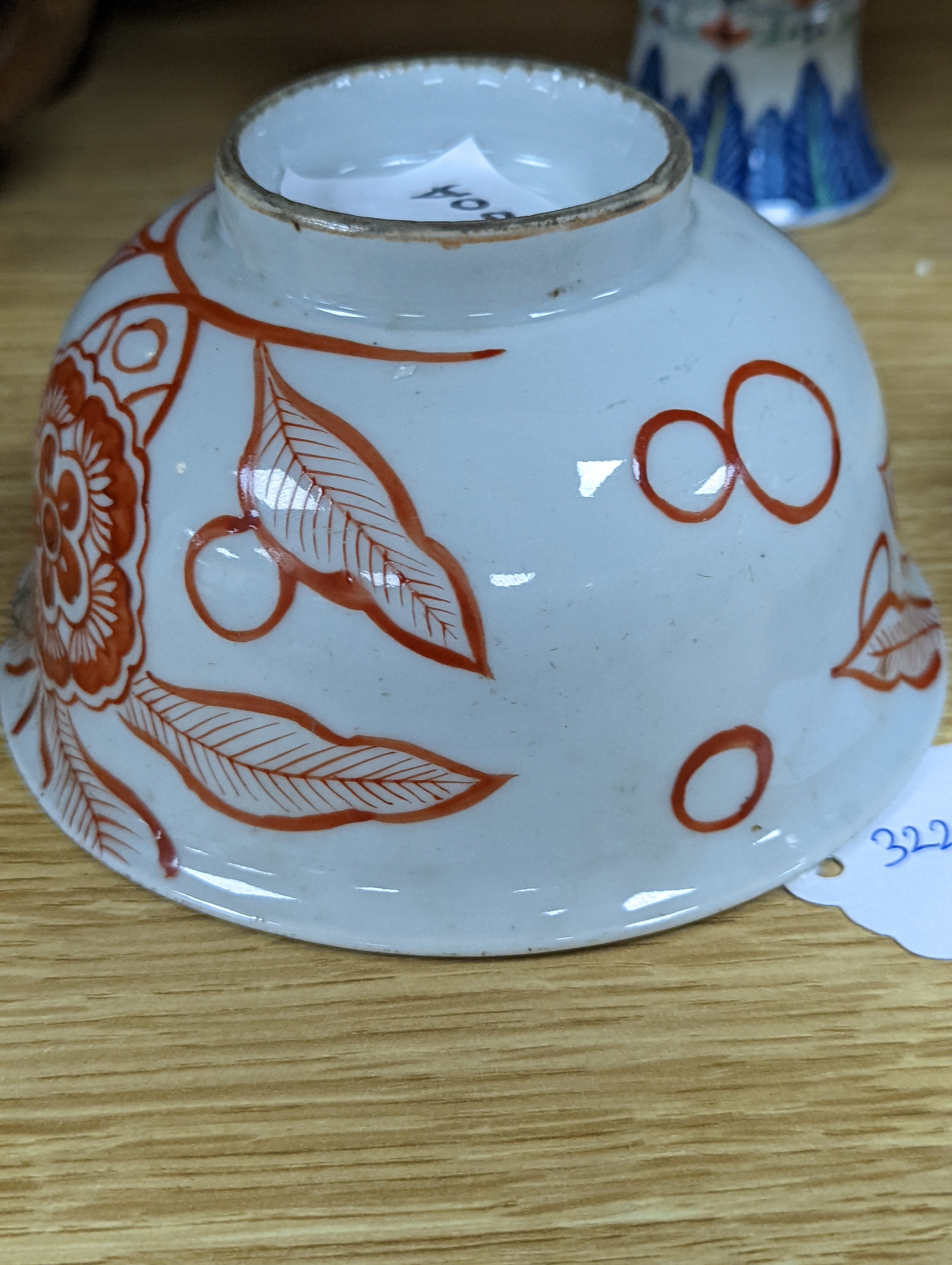 A Chinese blue and white water pipe vessel, a doucai stem dish and a Japanese Imari bowl, 19th century, (3)